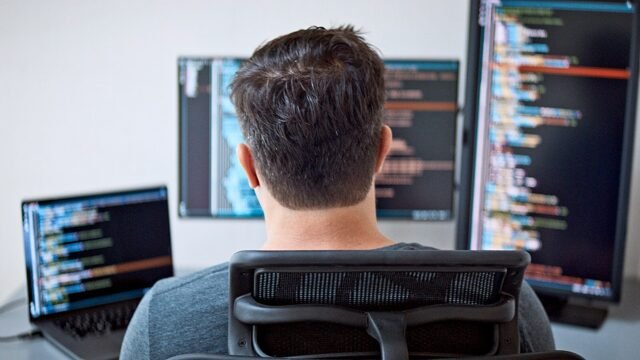 man-at-computer-with-extra-screens.jpg