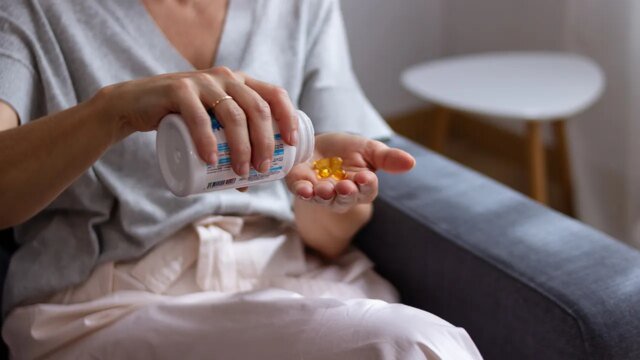 woman-pouring-supplement-in-hand.jpg