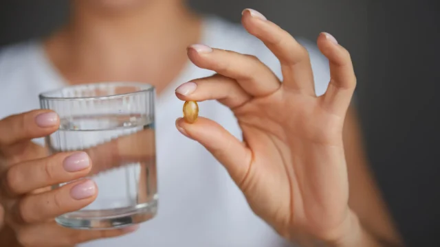 woman-holding-vitamin-d-omega-3-supplement-capsule.webp.webp