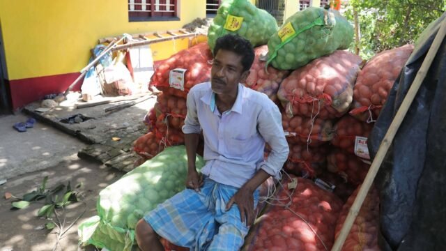 Farmer-Debabrata-Bera-infront-of-stacked-Potato-sacks-at-his-residence-in-Meghsa-village.-Express-ph.jpeg