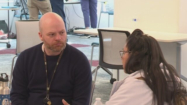 Portland-City-Councilor-Mitch-Green-right-talks-with-a-communtiy-member-duing-a-budget-open-house-Do.jpeg