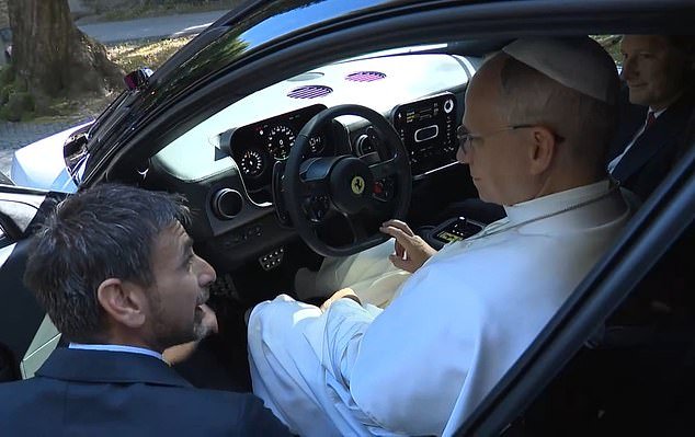 108911587-15853287-The_Pope_is_guided_through_the_controls_of_Ferrari_s_new_Luce_el-m-2_177990660079.jpeg